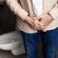Senior man experiencing prostate problems in bathroom